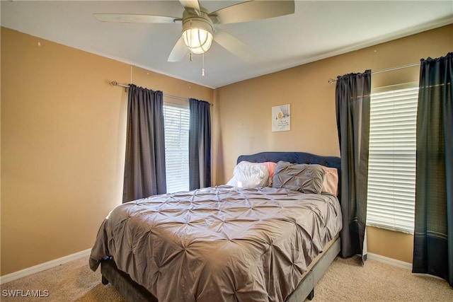 carpeted bedroom featuring a ceiling fan and baseboards