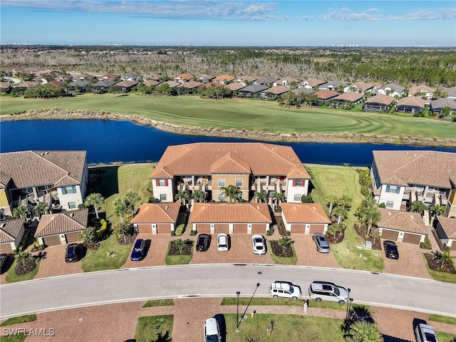 aerial view with golf course view, a water view, and a residential view