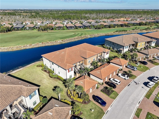 drone / aerial view with a residential view and a water view