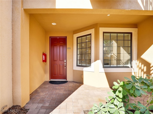 view of exterior entry with stucco siding