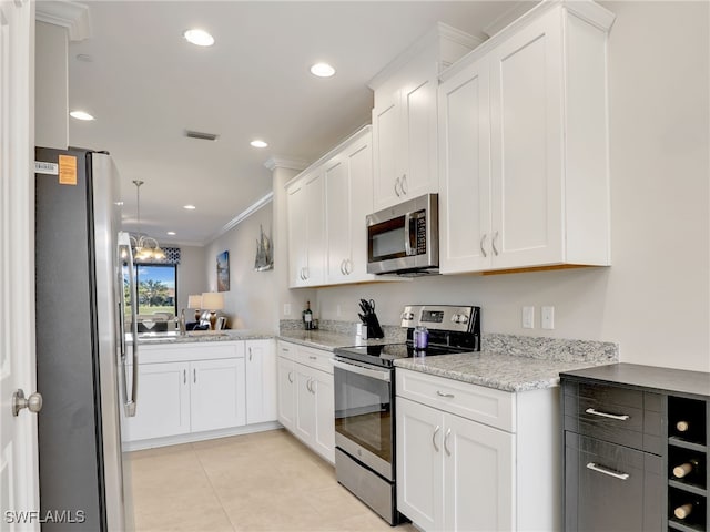 kitchen featuring light tile patterned floors, visible vents, appliances with stainless steel finishes, crown molding, and white cabinetry