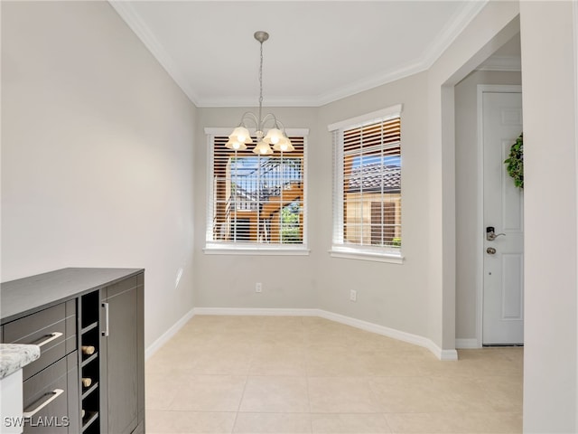 unfurnished dining area featuring baseboards, a chandelier, and crown molding