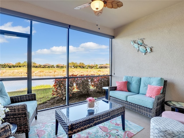 sunroom / solarium featuring a water view and a ceiling fan