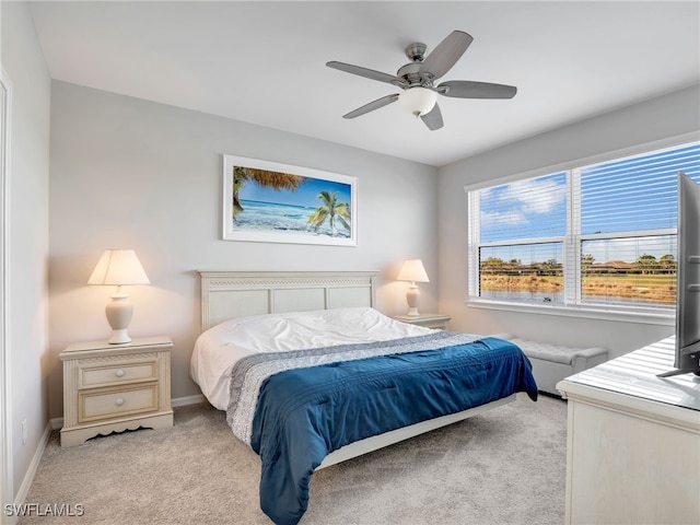 bedroom with ceiling fan, baseboards, and light colored carpet