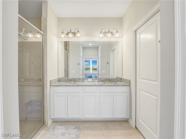 bathroom featuring a stall shower, a sink, and double vanity