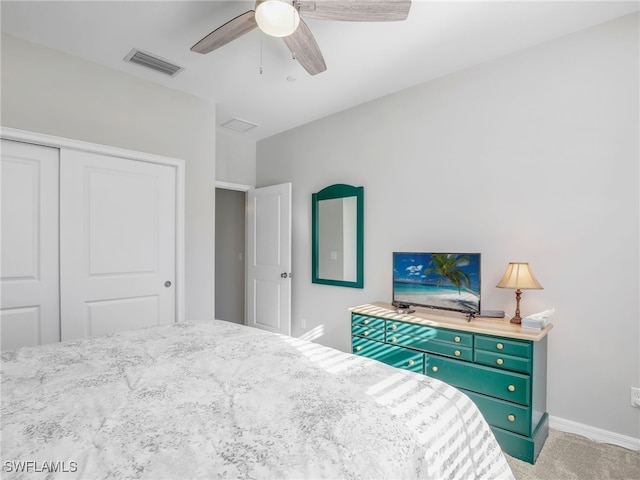 bedroom featuring baseboards, visible vents, a ceiling fan, carpet floors, and a closet