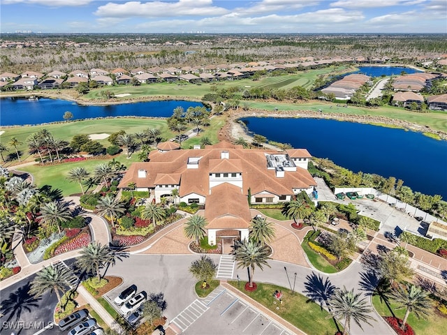 aerial view featuring golf course view, a water view, and a residential view