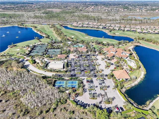 birds eye view of property with golf course view and a water view