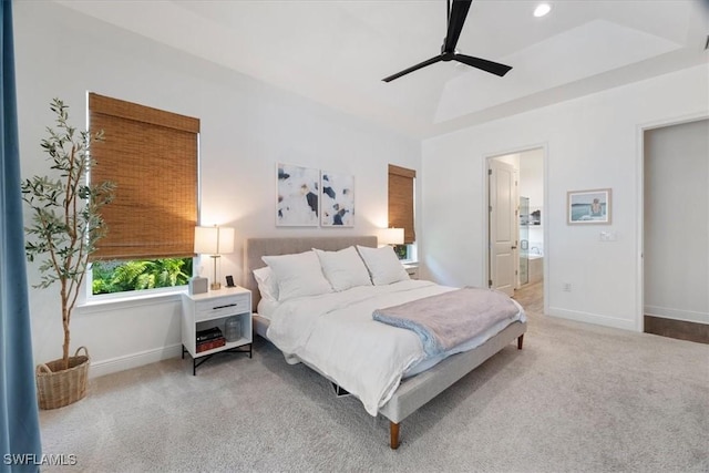 carpeted bedroom featuring a ceiling fan, recessed lighting, a raised ceiling, and baseboards