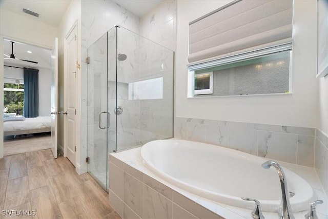 full bath featuring ensuite bathroom, wood finished floors, visible vents, a shower stall, and a bath