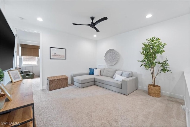 living room featuring recessed lighting, ceiling fan, baseboards, and light colored carpet