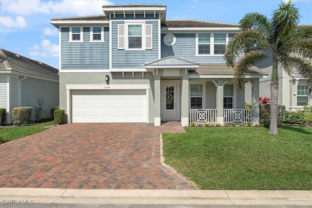 view of front of home with decorative driveway, stucco siding, a porch, a garage, and a front lawn