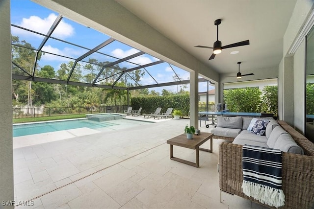 view of swimming pool featuring glass enclosure, a fenced backyard, a pool with connected hot tub, an outdoor living space, and a patio area