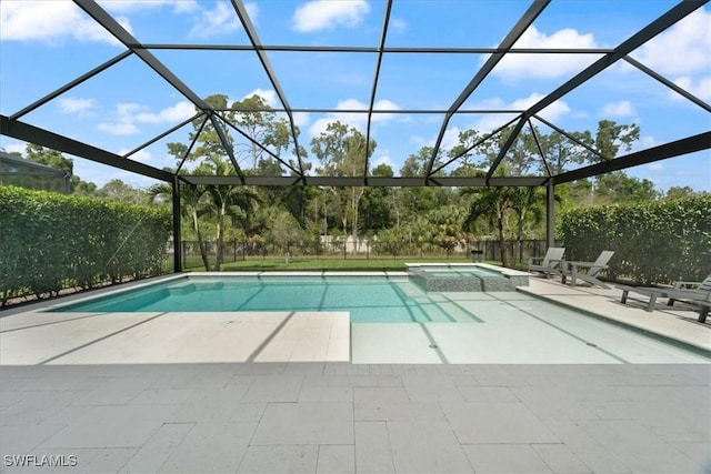 view of pool featuring glass enclosure, a patio, and a pool with connected hot tub