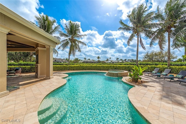 view of pool with a pool with connected hot tub and a patio