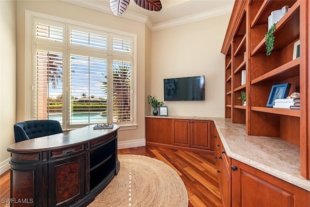 office area with crown molding, baseboards, and wood finished floors