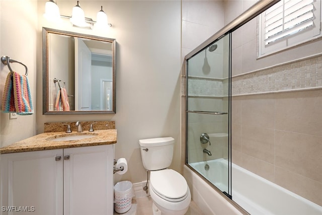 full bathroom featuring combined bath / shower with glass door, toilet, vanity, and baseboards