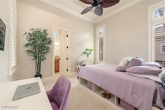 bedroom with a ceiling fan, baseboards, light carpet, crown molding, and connected bathroom