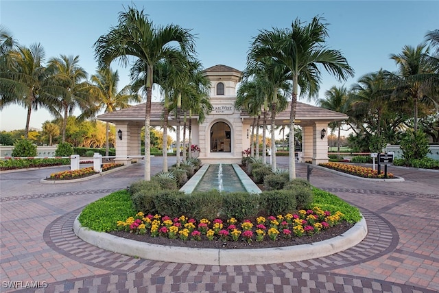 surrounding community featuring decorative driveway