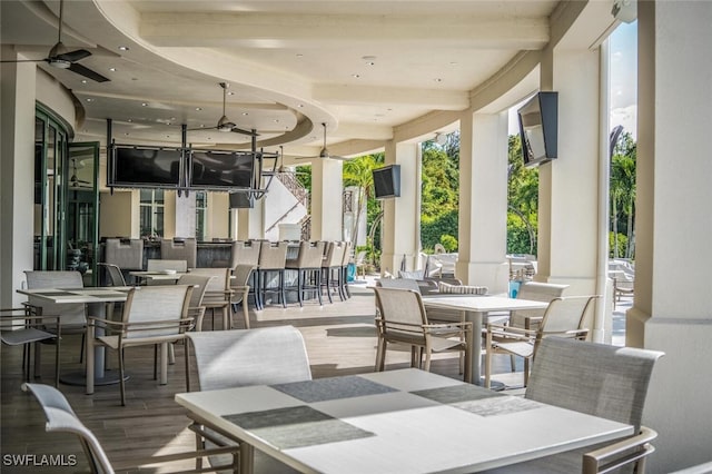 view of patio featuring outdoor dining area and a ceiling fan