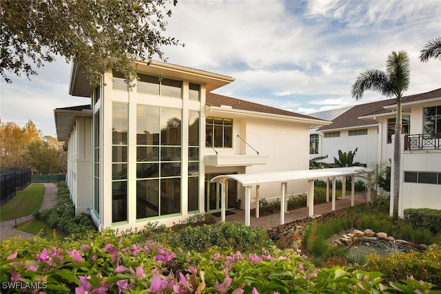 rear view of property featuring fence