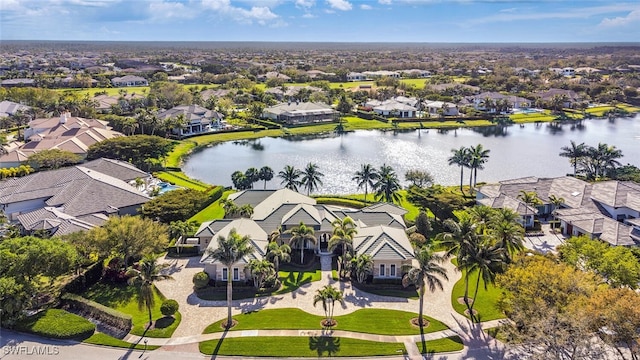 drone / aerial view with a residential view and a water view