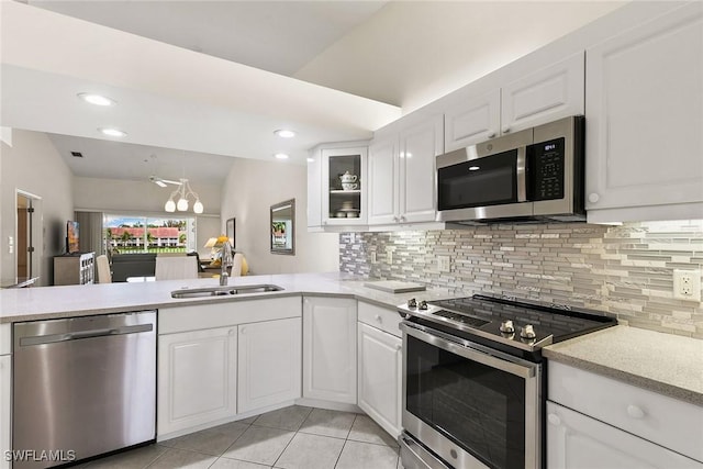 kitchen with white cabinets, appliances with stainless steel finishes, and light countertops