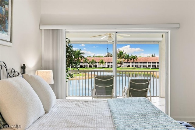 bedroom featuring a water view and access to outside