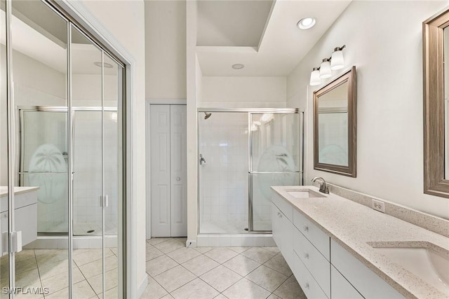 bathroom featuring a shower stall and a sink