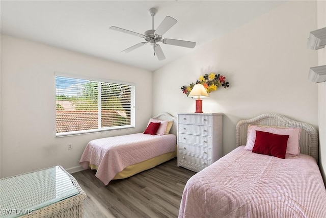 bedroom featuring ceiling fan, baseboards, and wood finished floors