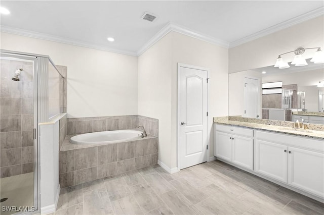 bathroom with visible vents, vanity, a bath, a stall shower, and crown molding