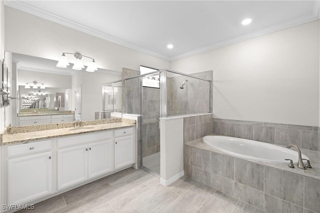 bathroom with a bath, a shower stall, vanity, and crown molding