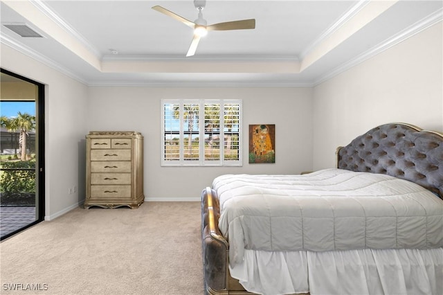 carpeted bedroom with a tray ceiling, access to outside, crown molding, and baseboards