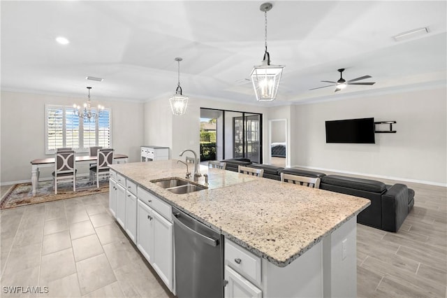 kitchen with white cabinets, ornamental molding, a kitchen island with sink, stainless steel dishwasher, and a sink