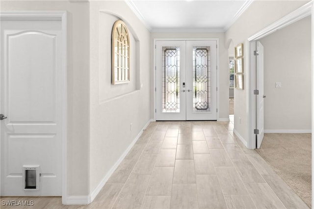 entryway featuring ornamental molding, french doors, and baseboards