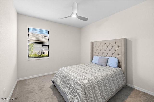 carpeted bedroom with ceiling fan and baseboards