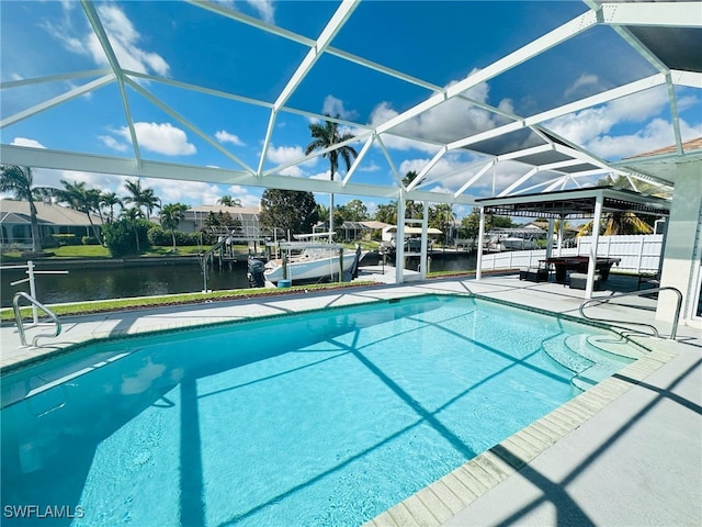 outdoor pool featuring a water view, a lanai, fence, and a patio