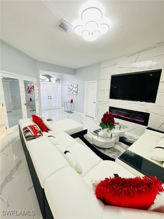 living room featuring french doors and visible vents