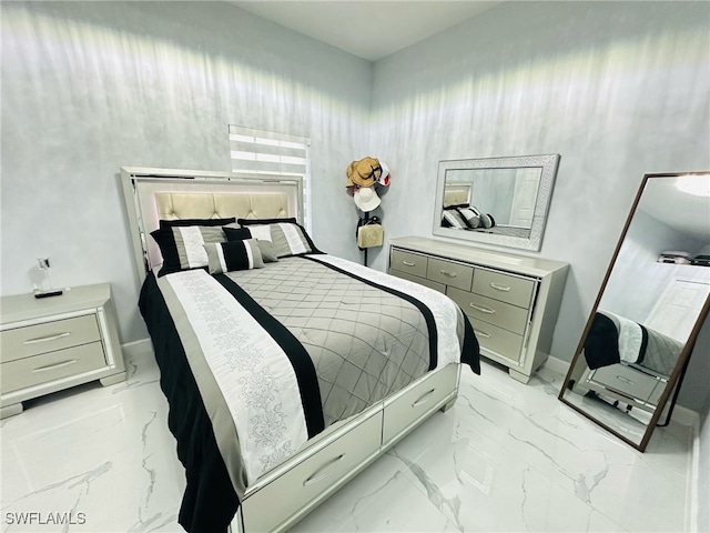 bedroom with marble finish floor and baseboards