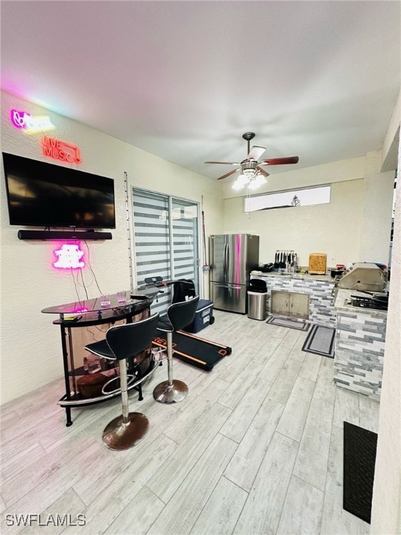 interior space with ceiling fan and wood finished floors