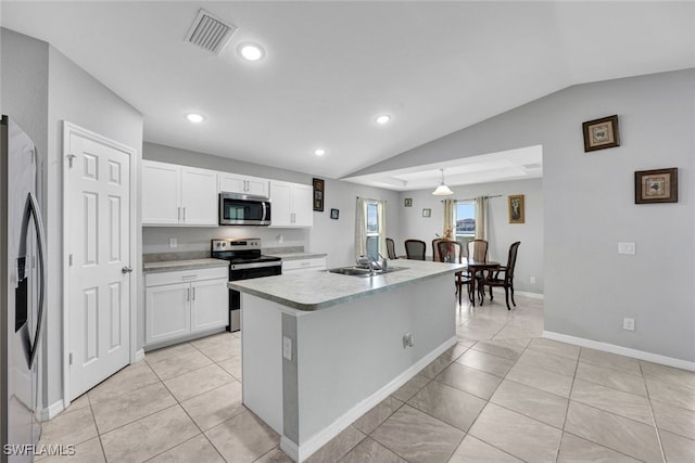 kitchen with light countertops, visible vents, appliances with stainless steel finishes, white cabinetry, and a sink