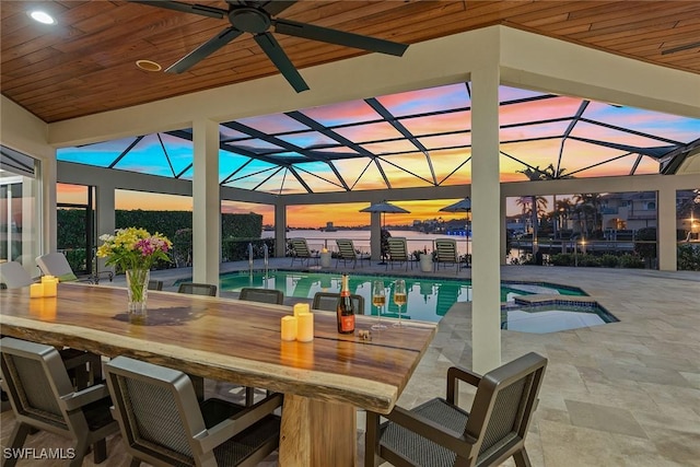 view of pool featuring a patio, ceiling fan, outdoor dry bar, a lanai, and a pool with connected hot tub