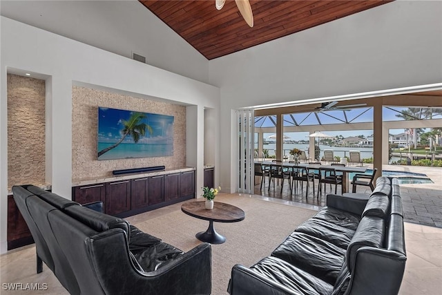 living area with ceiling fan, high vaulted ceiling, a sunroom, and wood ceiling