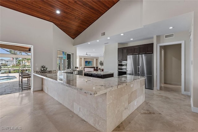 kitchen featuring stainless steel appliances, wooden ceiling, visible vents, and light stone countertops