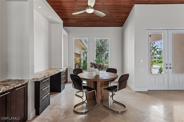 dining space with wooden ceiling, a ceiling fan, baseboards, vaulted ceiling, and french doors