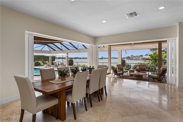 dining space with a healthy amount of sunlight, baseboards, visible vents, and recessed lighting