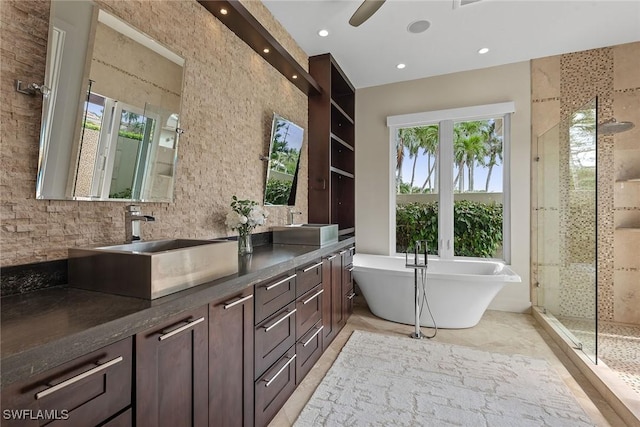 bathroom featuring recessed lighting, a sink, a freestanding bath, double vanity, and a stall shower