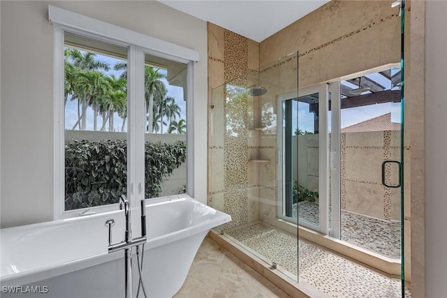 full bathroom featuring a soaking tub and a shower stall