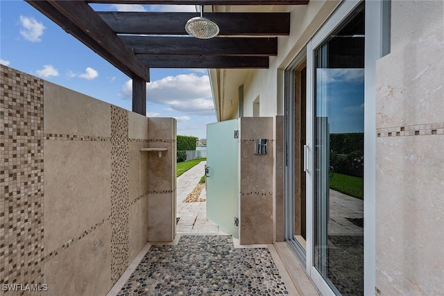 entryway featuring beam ceiling