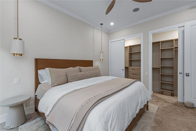 bedroom featuring ceiling fan, ornamental molding, multiple closets, and recessed lighting